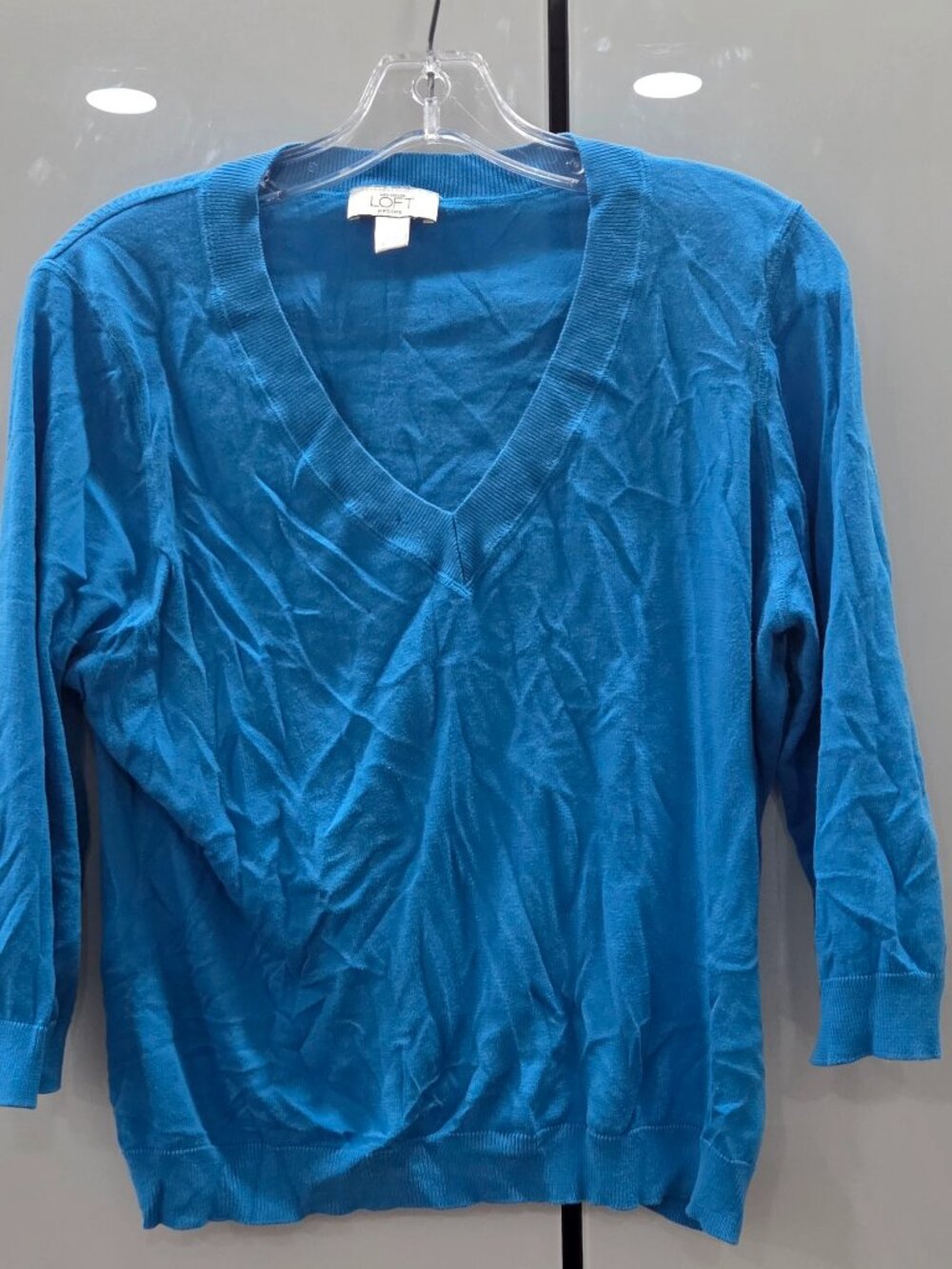 LOFT blue lightweight V-neck sweater featuring a ribbed neckline, cuffs